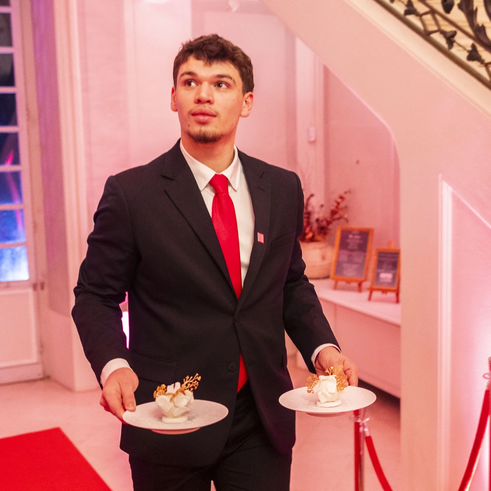 étudiant serveur qui sert des clients au restaurant